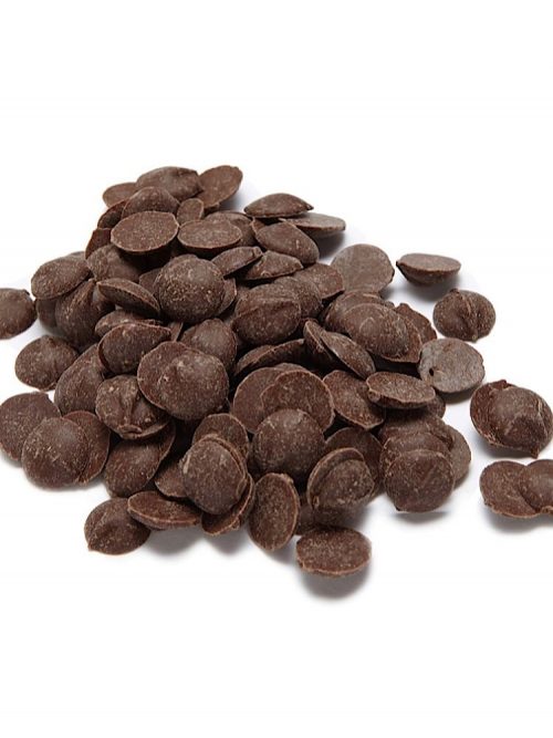 photograph of a pile of dark carob drops for dogs on a white background