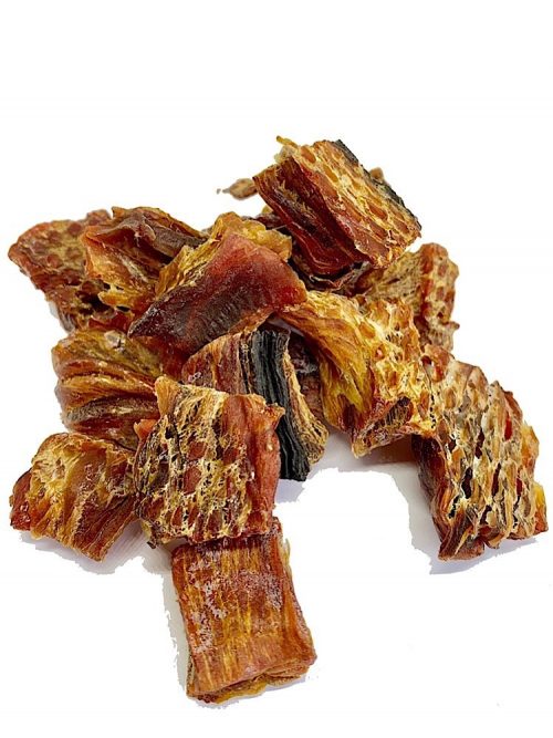 Photograph of dried tuna fish for dogs on top of each other on a white background